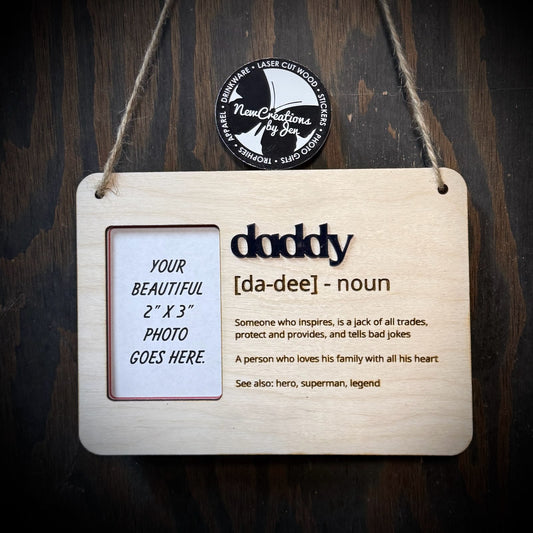Wooden plaque with 'daddy' definition and photo placeholder on a dark wooden background