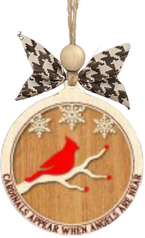 A circular wooden ornament with a red bird and snowflakes, hanging from a ribbon with a bow.