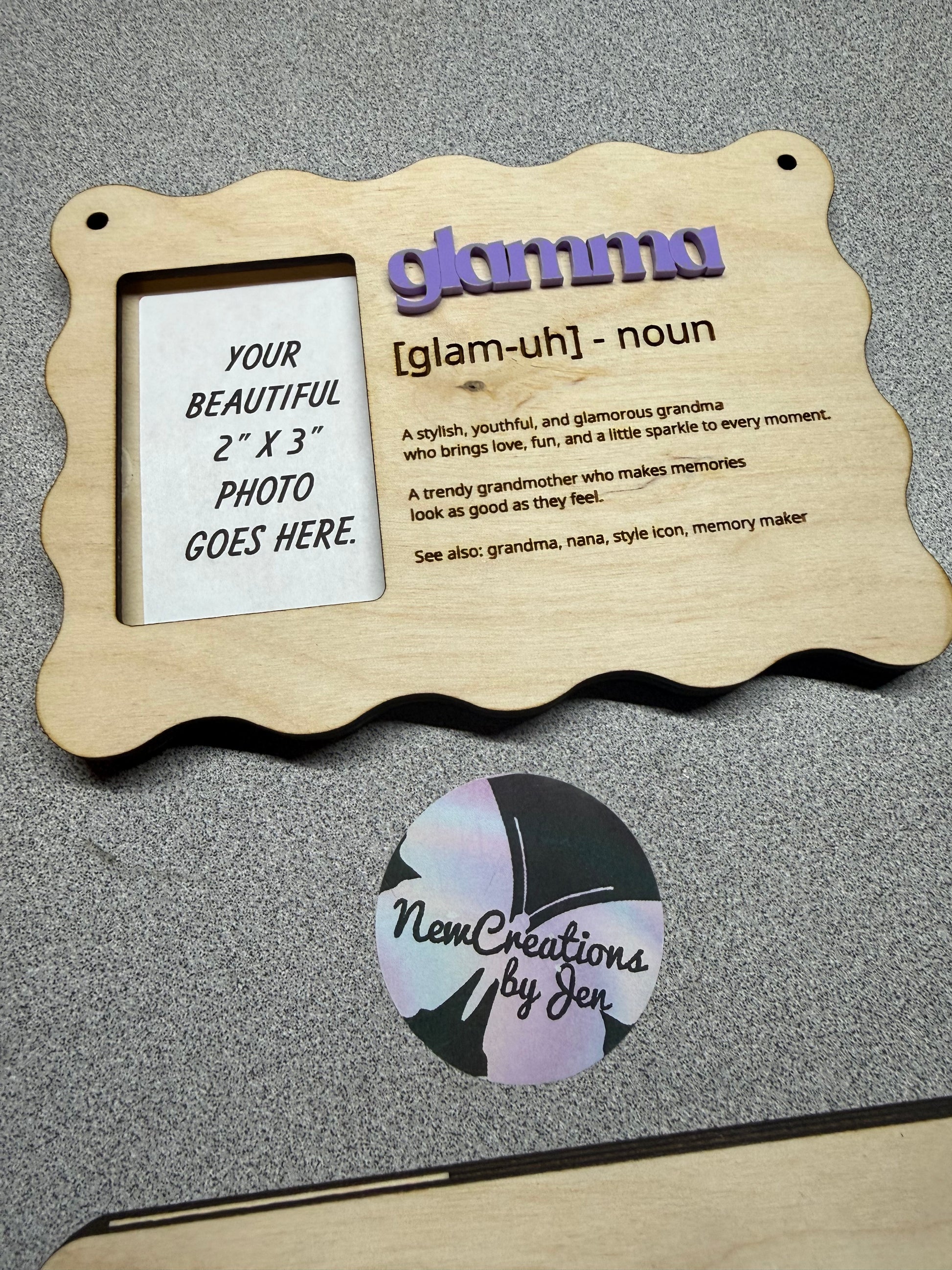Wooden photo frame with customizable text and a round sticker on a gray surface