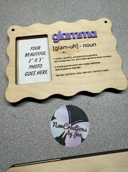Wooden photo frame with customizable text and a round sticker on a gray surface