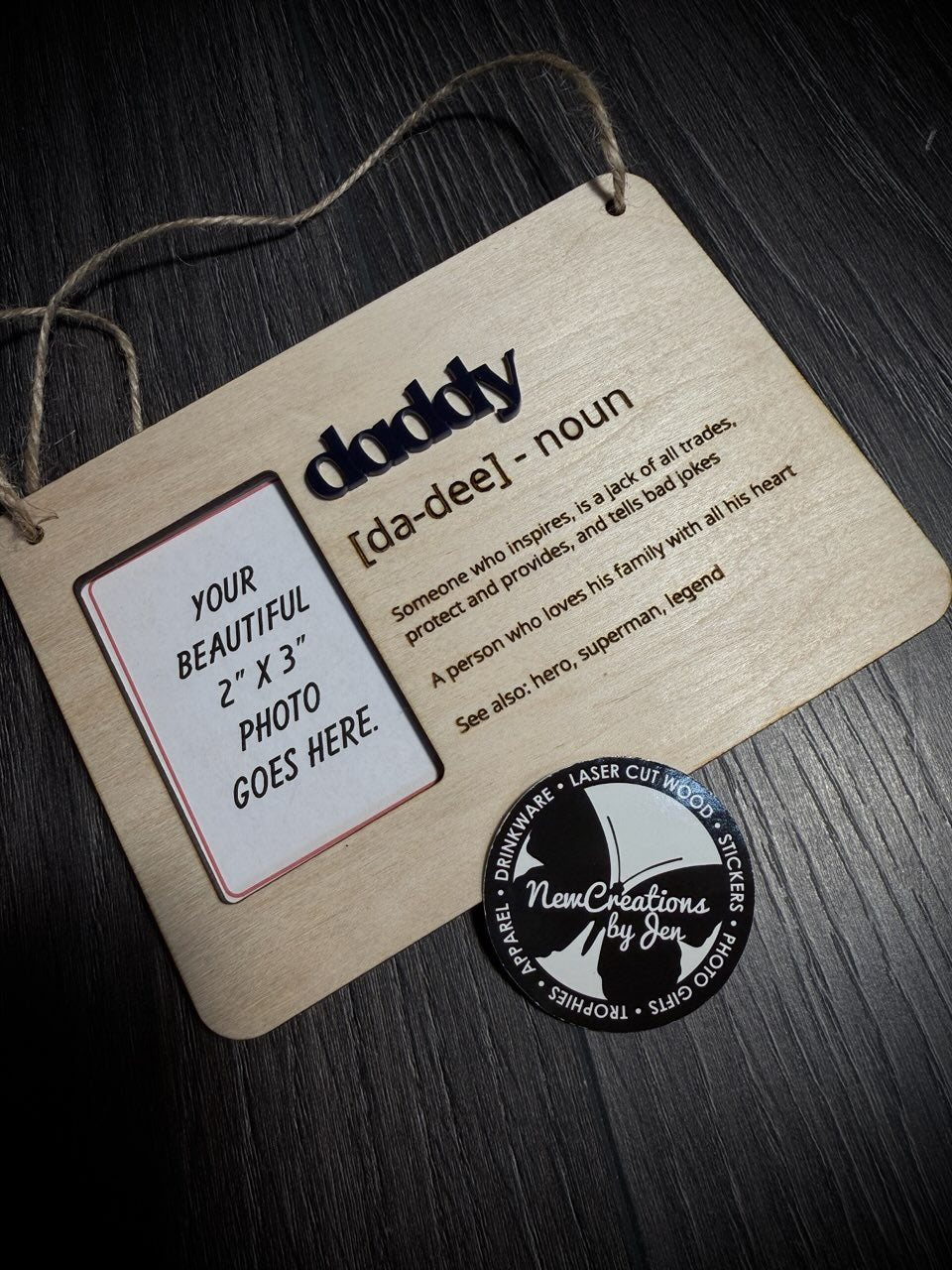 Wooden plaque with text and a photo placeholder on a dark surface, featuring the brand 'New Creations by Jen'.