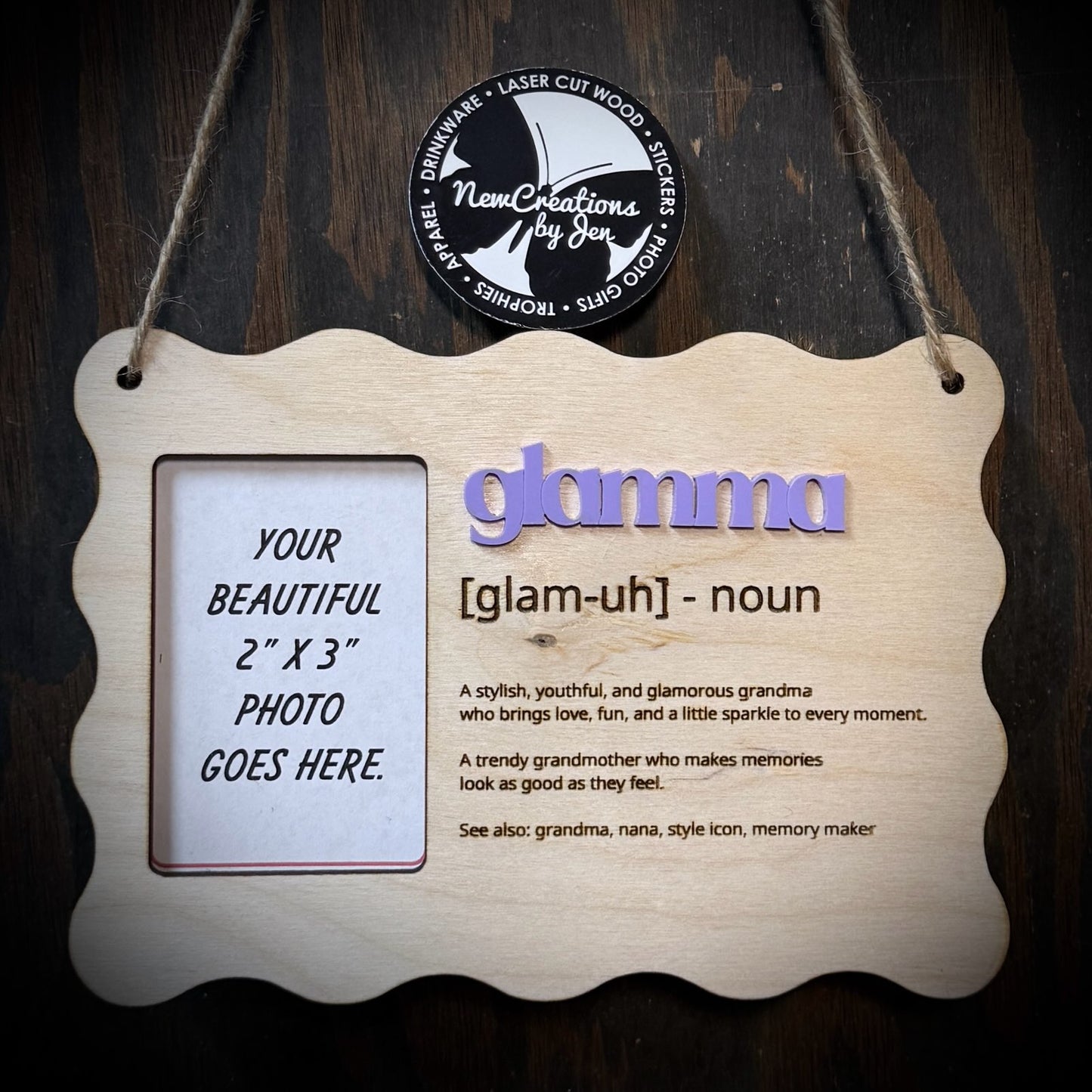 Wooden photo frame with 'gamma' definition and photo placeholder on a dark background