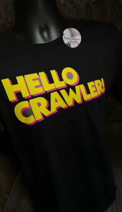 Black shirt with 'HELLO CRAWLER!' text in yellow and pink on a dark background