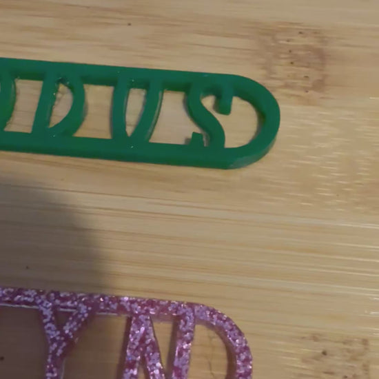 three personalized bubble wands in blue green and pink glitter