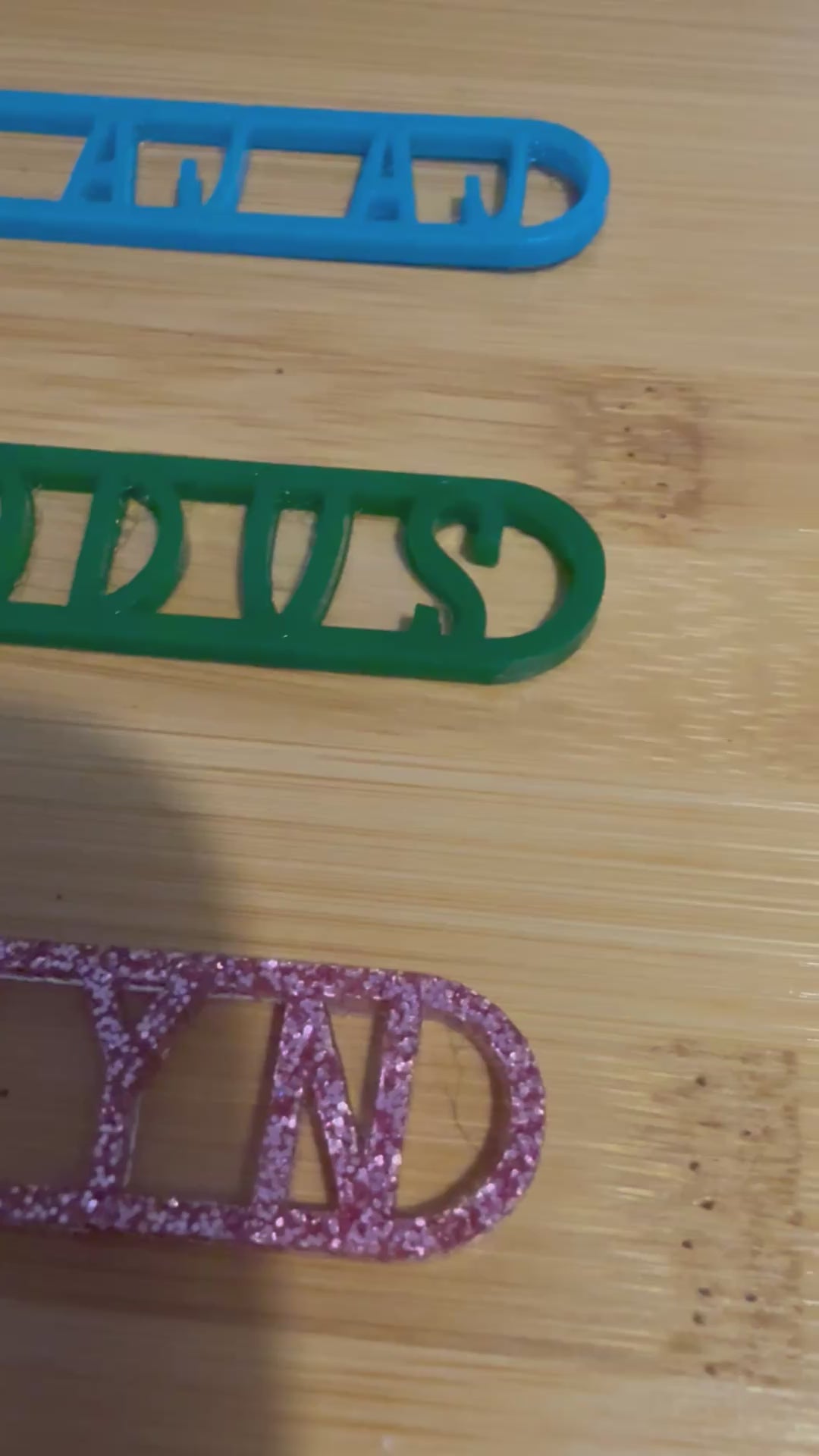 three personalized bubble wands in blue green and pink glitter